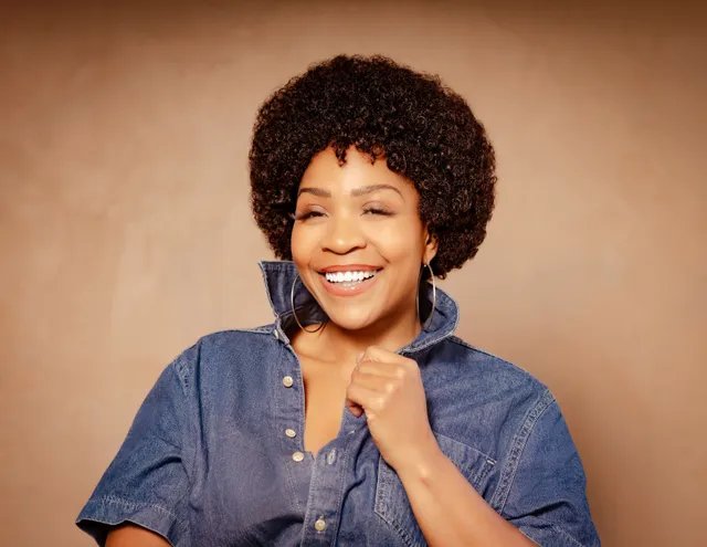 Divine Brown as Minnie Riperton in a denim shirt, laughing with collar popped