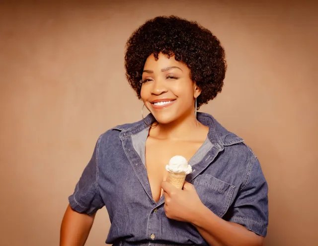 Divine Brown as Minnie Riperton in denim, laughing